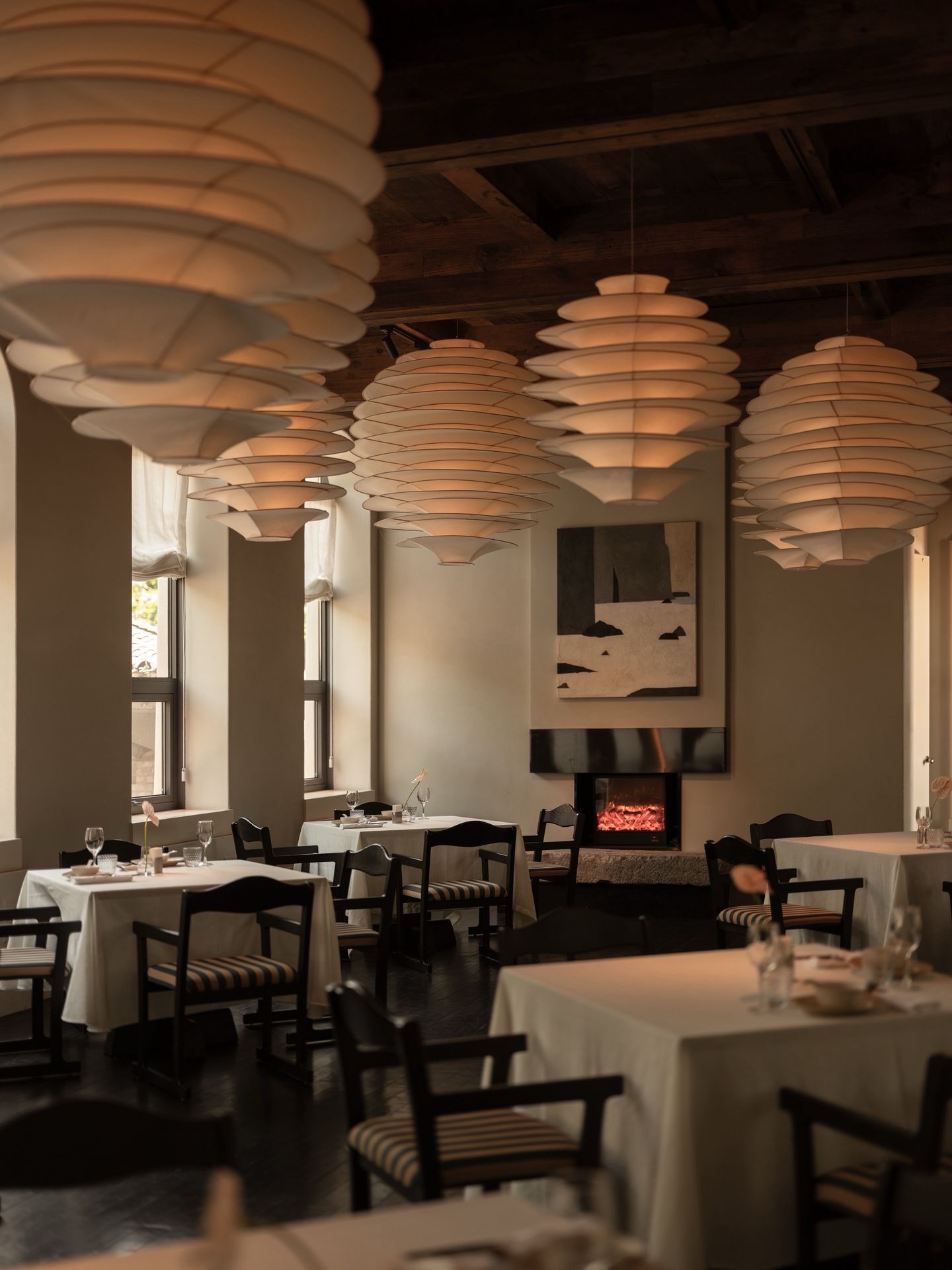 Dining-room interior with paper lanterns and a fireplace